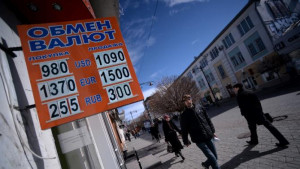 man walks past a foreign currency exchange office in Simferopol on ...
