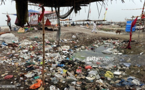 News Photo : Plastic bags and garbage litter the banks of the...
