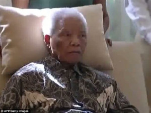 Motionless: Mandela sat up in an armchair with the aid of a cushion ...