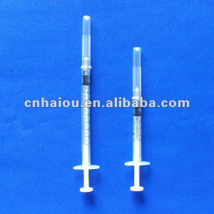 Disposable safety syringe with retractable needle