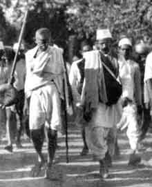 Gandhi breaks the salt laws at Dandi beach, April 6, 1930.