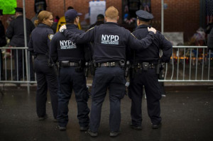 New York City Police officers pause as they visit a makeshift memorial ...