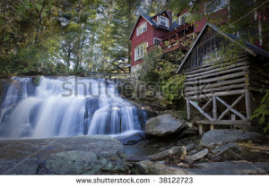 stock-photo-waterfall-in-forest-with-house-and-log-cabin-38122723.jpg