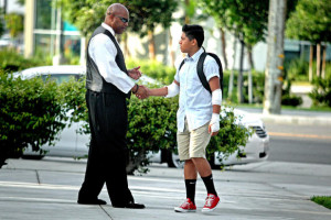 Principal Todd Irving, left, greets Isaac Martinez, 13, before school ...