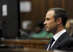 Oscar Pistorius takes notes during court proceedings at the North ...