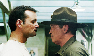Bill Murray and Warren Oates talk closely in Stripes