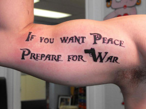 ... letters, this tattoo with a gun shape hidden in the words looks cool