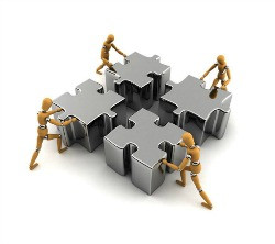 putting together a jigsaw, representing team work. Team development ...