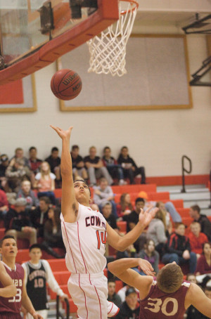 Devon Arellano pushes up a shot for the Cowboys in Wednesday’s game ...