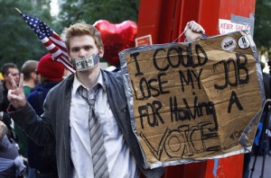 Wall Street campaign demonstrator stands in Zuccotti Park, near Wall ...