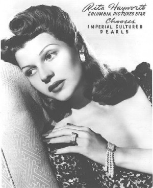 Above the gorgeous Rita Hayworth with a side rolled victory roll with ...