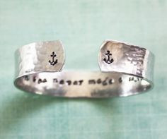 An anchor bracelet with an encouraging message stamped on the inside ...