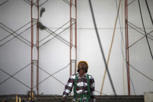 worker walks in a swimming pool complex that is being built in Nay ...