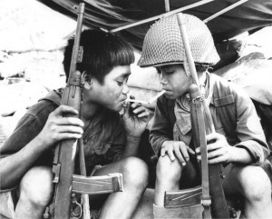 Vietcong child fighters share a cigarette, 1967