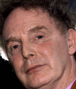 Malcolm McLaren exhales smoke as he sits in his north London studio in ...