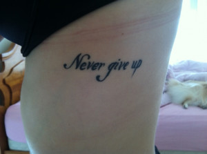 Never give up rib tattoo