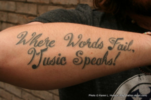 Tattoo of a musical quote in script lettering on the arm of Saving ...