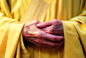 Buddhist monk with hands folded