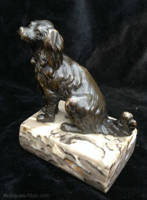 An appealing Bronze study of a Cavalier King Charles Spaniel seated
