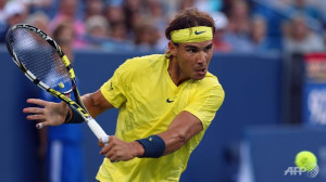 Rafael Nadal of Spain returns a shot to Roger Federer of Switzerland ...