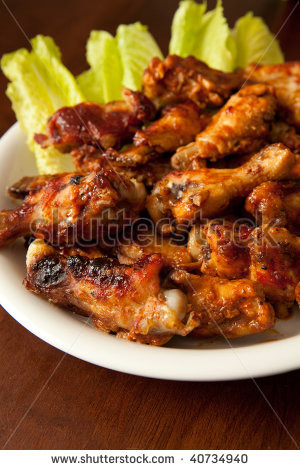 Plate of BBQ chicken wings on wood table with shallow dof - stock ...
