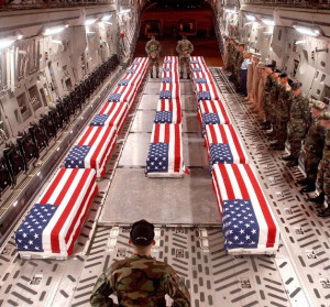 American flag over coffins in plane
