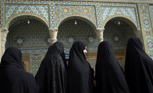 Veiled Iranian women wait in a queue to vote at a polling station in ...
