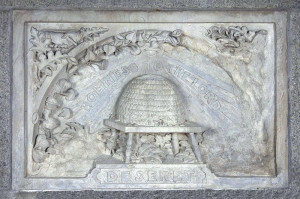rectangular stone plaque dominated by a central relief carving of a ...