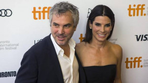 Alfonso Cuaron and Sandra Bullock pose for a photograph on the red ...