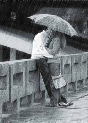 Kissing in the rain with umbrella