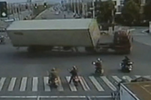 Chinese big rig tips going too fast around corner