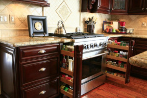 Kitchen cabinet trends including pull out spice racks.