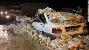 The wreckage of a car amid rubble in the Iranian western city of ...