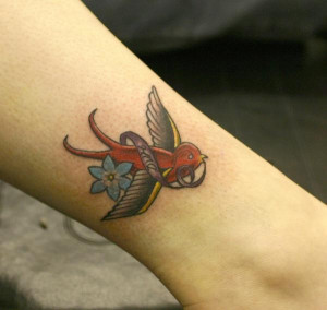 beautiful little swallow birdie flying with a flower and scroll ...