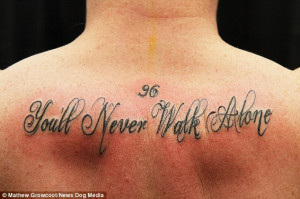 ... Alone' tattooed across his back to raise funds for a dying boy with a