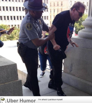 black police officer helping a KKK member suffering from sunstroke