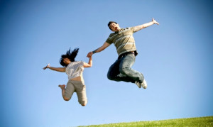 Woman And Man Jumping For Joy