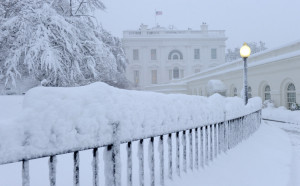 Snow covers a decorative iron fence at the White House in Washington ...
