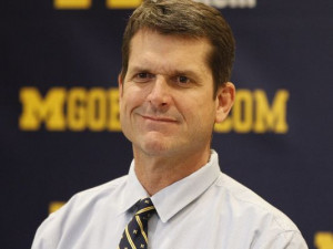 Michigan football coach Jim Harbaugh listens to a question Feb. 4 ...