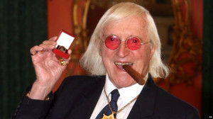 Sir Jimmy Savile in 2008 with his award for services as a Bevin Boy ...