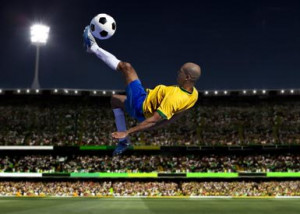 Soccer player kicking in stadium - Photo and Co/ The Image Bank/ Getty ...
