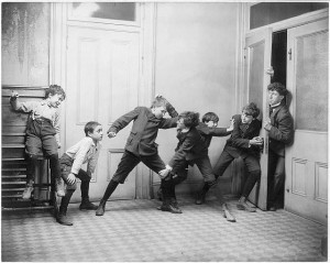 Two boys fighting in a schoolroom while two others try to prevent ...