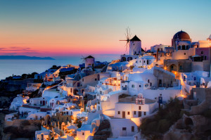 ... sun setting over the picturesque town of Oia, Greece by Pedro Szekely