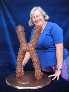 Dr Elisabeth Rosser with X-Chromisome in copper by Sandra Reeves