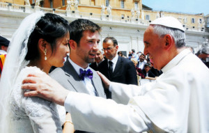 Pope Francis blessing a couple