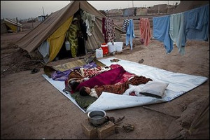 from Swat valley sleep next to their tent at the Jalozai refugee ...