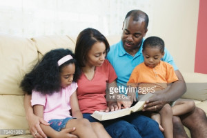 ... -free Image: Parents with children on sofa reading bible smiling