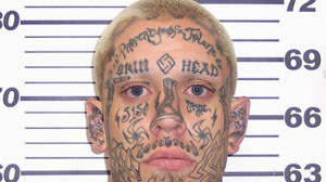 No mistaken identity: skin head under arrest poses for a mug shot ...