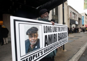 Nello Ramsey of East Orange, N.J., holds a sign outside the funeral ...