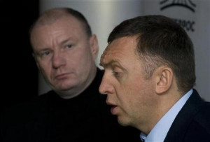Norilsk Nickel Chairman Vladimir Potanin (L) listens as Oleg Deripaska ...